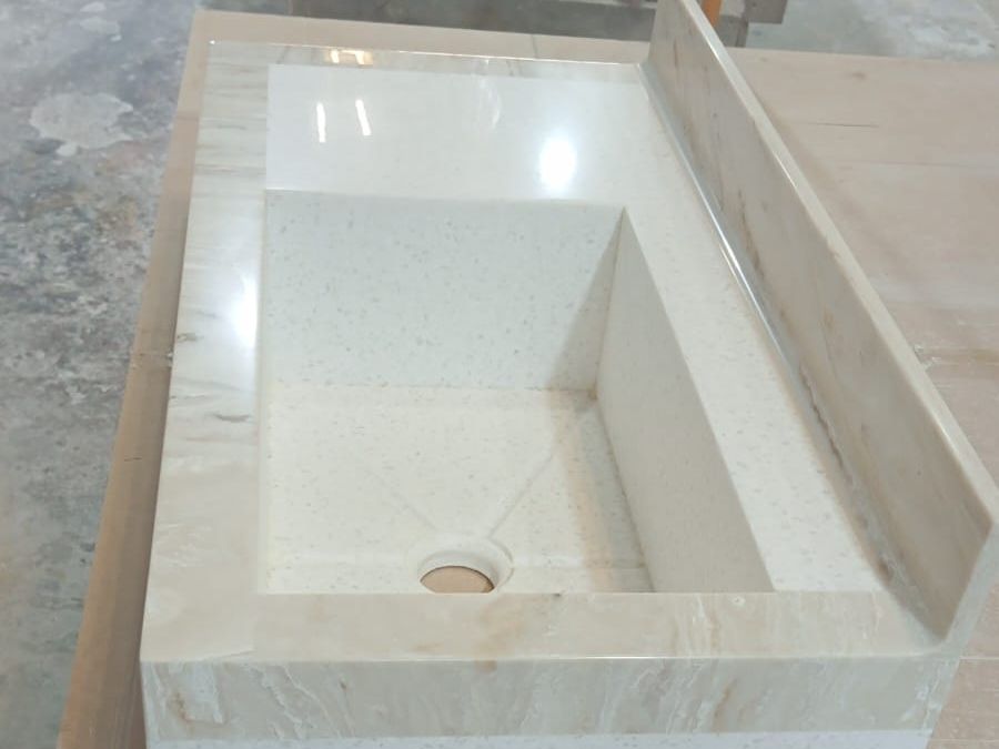 Lavabo rectangular integrado en una cubierta clara con respaldo, visto desde arriba